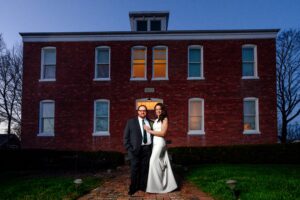 Chandrika and Andy standing in front of the School House. 